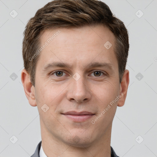 Joyful white young-adult male with short  brown hair and grey eyes