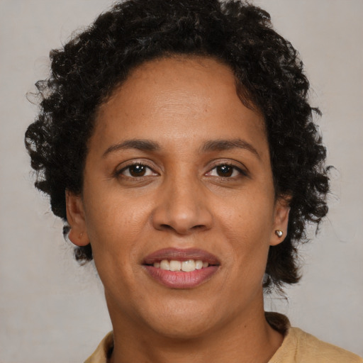 Joyful black adult female with short  brown hair and brown eyes