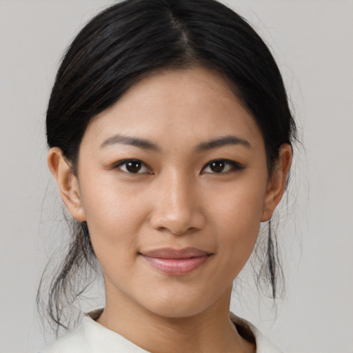 Joyful asian young-adult female with medium  brown hair and brown eyes