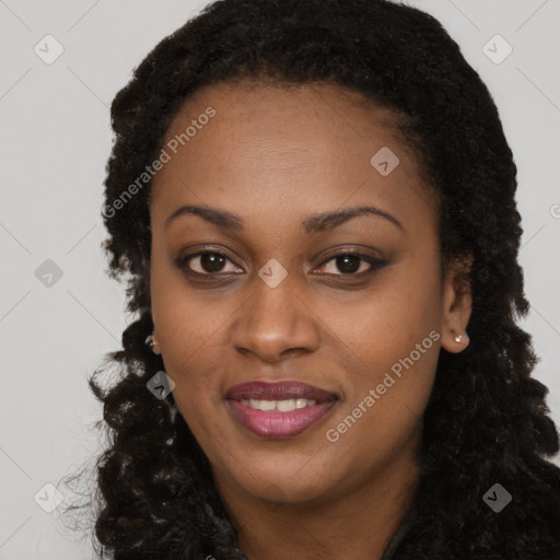 Joyful black young-adult female with long  brown hair and brown eyes