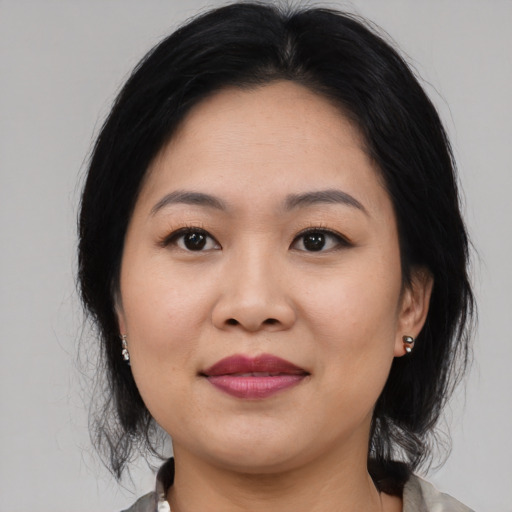 Joyful asian young-adult female with medium  black hair and brown eyes