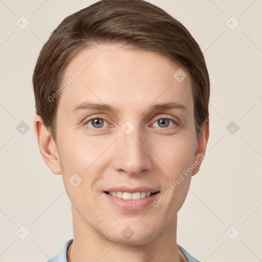 Joyful white young-adult male with short  brown hair and grey eyes