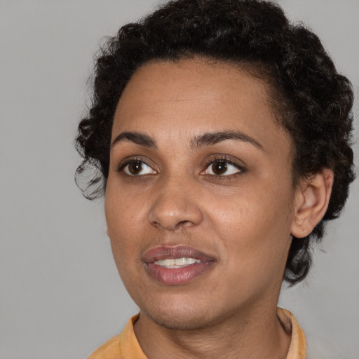 Joyful black young-adult female with short  brown hair and brown eyes