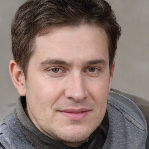 Joyful white adult male with short  brown hair and grey eyes