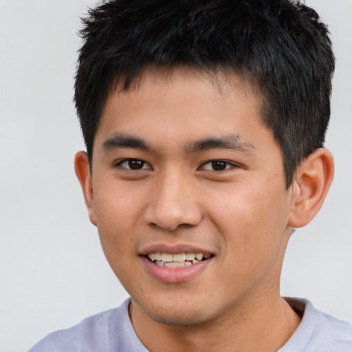 Joyful asian young-adult male with short  brown hair and brown eyes
