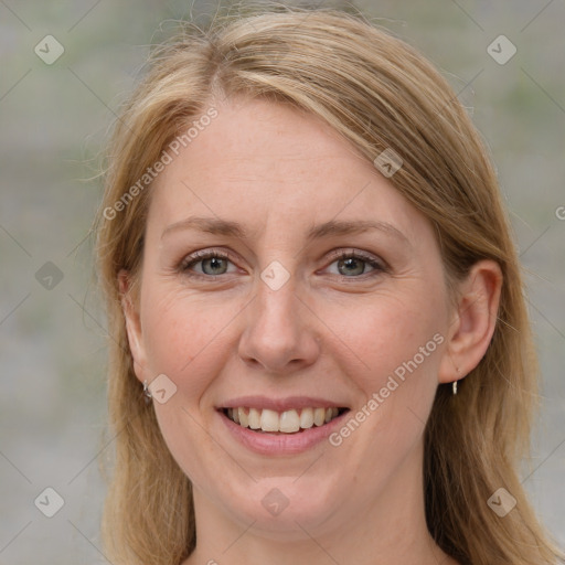 Joyful white adult female with medium  brown hair and blue eyes