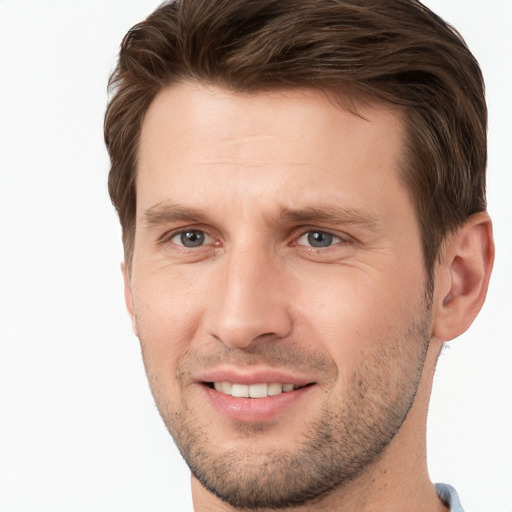 Joyful white young-adult male with short  brown hair and grey eyes