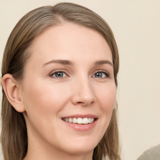 Joyful white young-adult female with long  brown hair and grey eyes