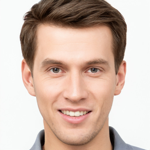 Joyful white young-adult male with short  brown hair and grey eyes