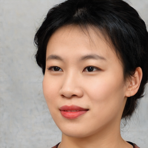 Joyful asian young-adult female with medium  black hair and brown eyes
