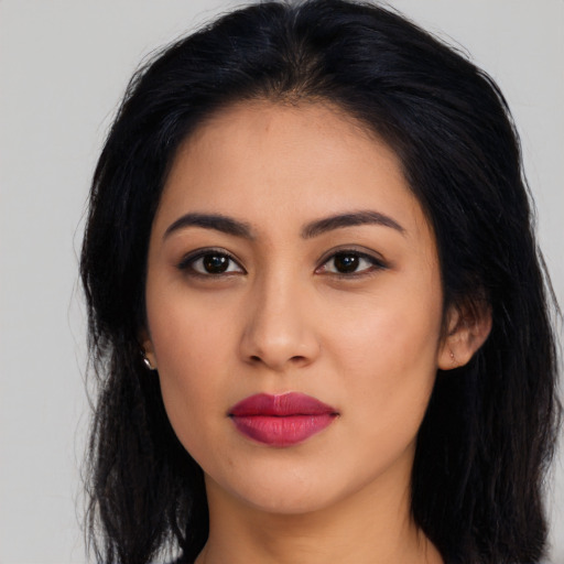Joyful latino young-adult female with long  black hair and brown eyes