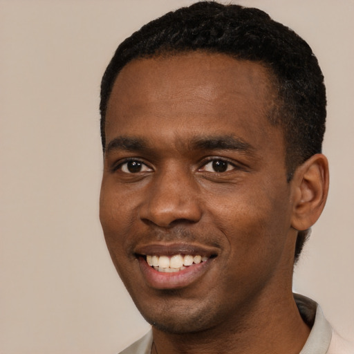 Joyful black young-adult male with short  black hair and brown eyes