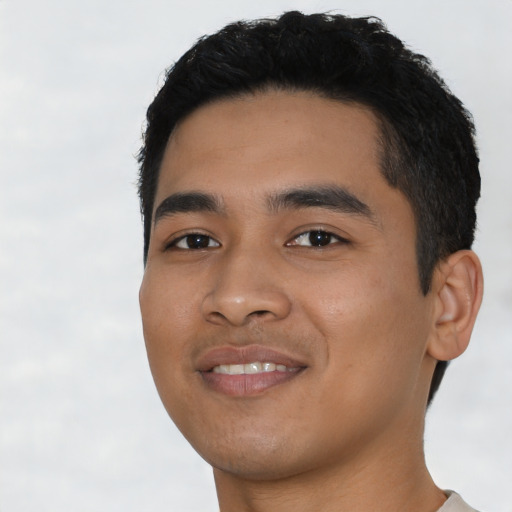 Joyful asian young-adult male with short  black hair and brown eyes