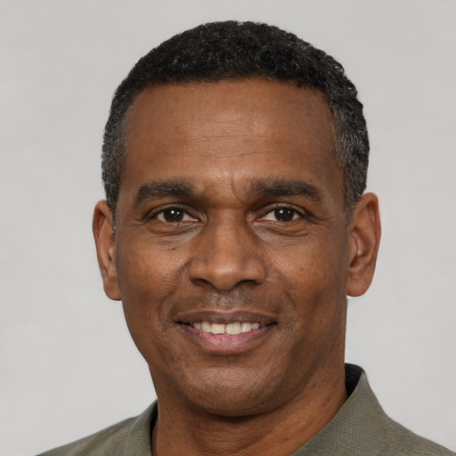 Joyful black adult male with short  black hair and brown eyes