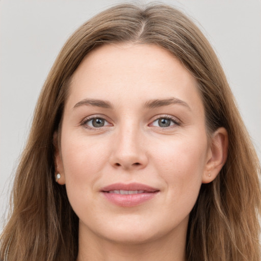 Joyful white young-adult female with long  brown hair and grey eyes