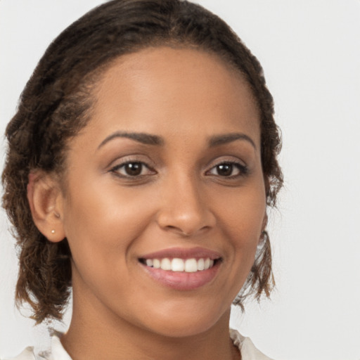 Joyful latino young-adult female with long  brown hair and brown eyes