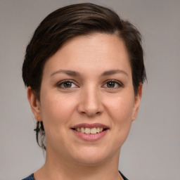 Joyful white young-adult female with medium  brown hair and brown eyes