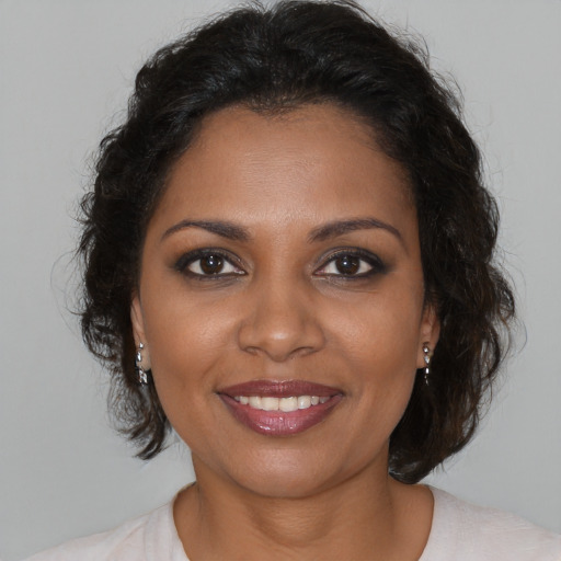 Joyful black young-adult female with medium  brown hair and brown eyes