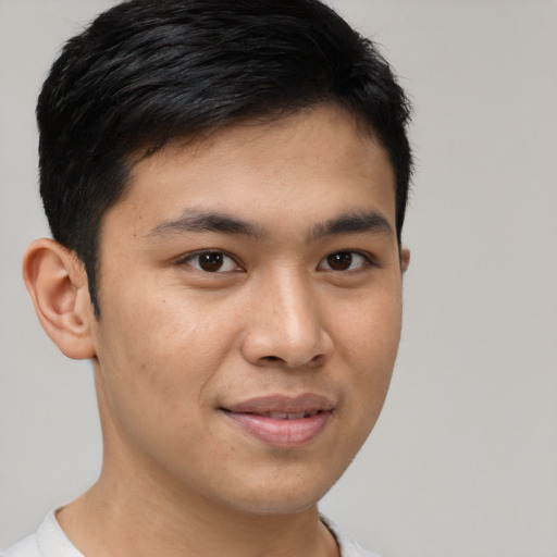Joyful asian young-adult male with short  brown hair and brown eyes