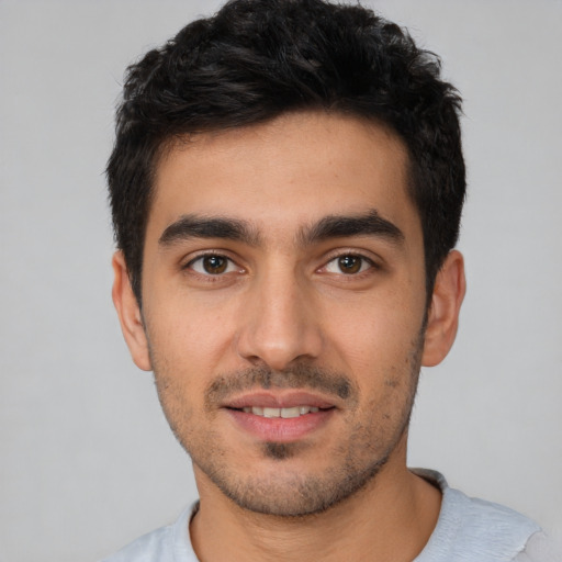 Joyful white young-adult male with short  black hair and brown eyes