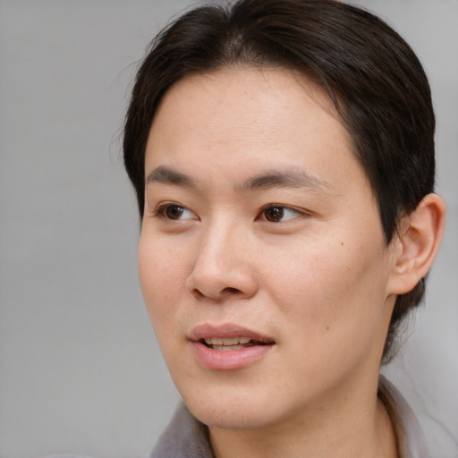 Joyful asian young-adult male with medium  brown hair and brown eyes