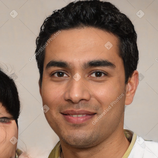 Joyful latino young-adult male with short  black hair and brown eyes