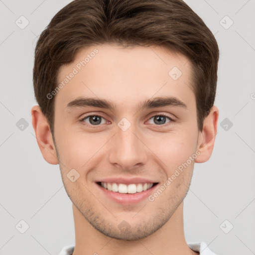 Joyful white young-adult male with short  brown hair and grey eyes