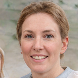 Joyful white adult female with medium  brown hair and grey eyes