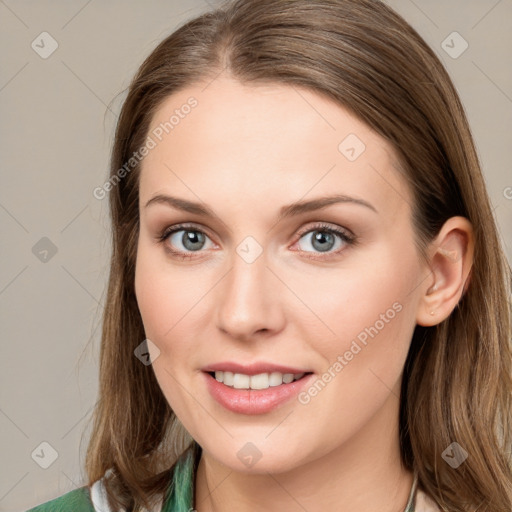 Joyful white young-adult female with long  brown hair and blue eyes