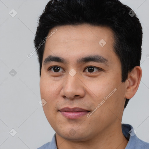 Joyful asian young-adult male with short  black hair and brown eyes