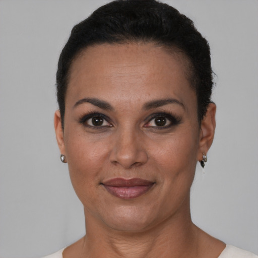 Joyful black adult female with short  brown hair and brown eyes