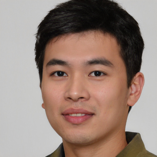 Joyful asian young-adult male with short  black hair and brown eyes