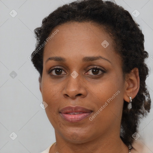 Joyful black young-adult female with short  brown hair and brown eyes