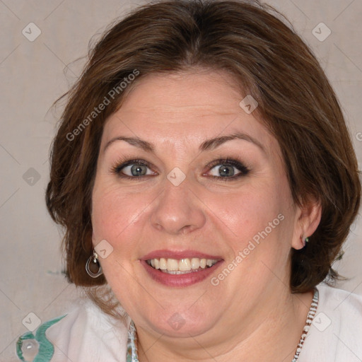 Joyful white adult female with medium  brown hair and blue eyes