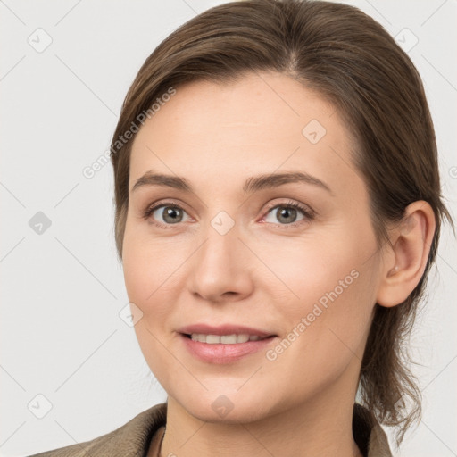 Joyful white young-adult female with medium  brown hair and grey eyes