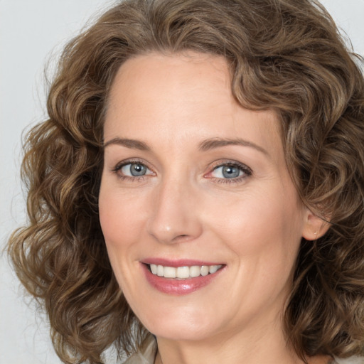 Joyful white young-adult female with medium  brown hair and green eyes