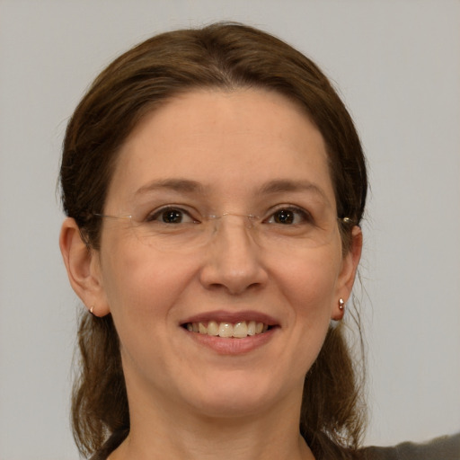 Joyful white young-adult female with medium  brown hair and grey eyes