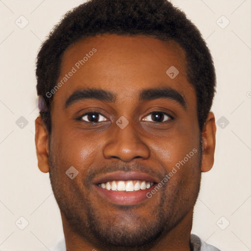 Joyful black young-adult male with short  black hair and brown eyes