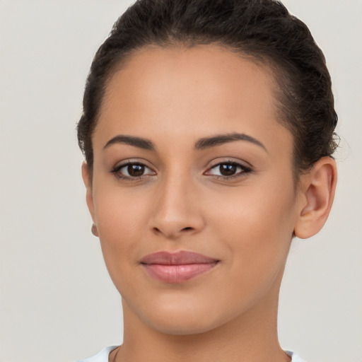 Joyful latino young-adult female with short  brown hair and brown eyes