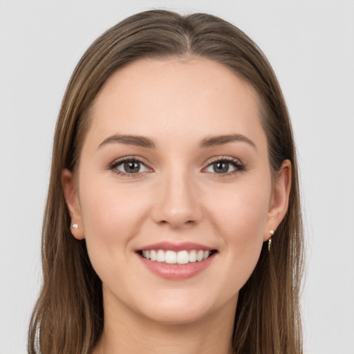 Joyful white young-adult female with long  brown hair and grey eyes