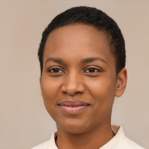 Joyful black young-adult female with short  black hair and brown eyes