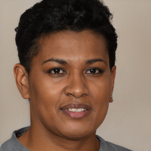 Joyful black young-adult female with short  brown hair and brown eyes