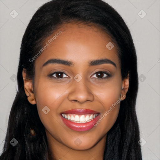 Joyful black young-adult female with long  black hair and brown eyes