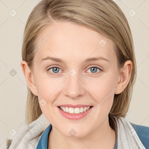 Joyful white young-adult female with medium  brown hair and blue eyes