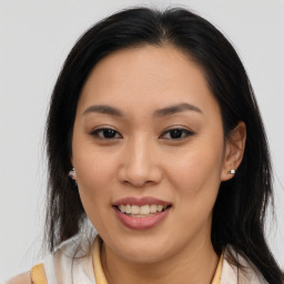 Joyful asian young-adult female with long  brown hair and brown eyes