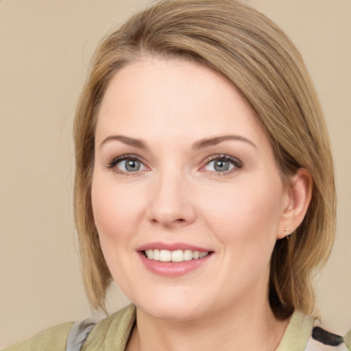 Joyful white young-adult female with medium  brown hair and green eyes