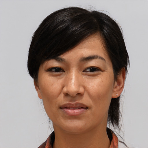 Joyful asian adult female with medium  black hair and brown eyes
