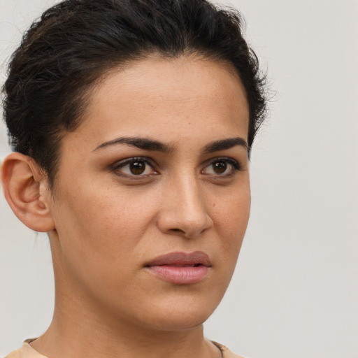 Joyful latino young-adult female with short  brown hair and brown eyes