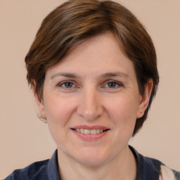 Joyful white adult female with medium  brown hair and brown eyes