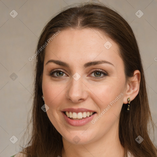 Joyful white young-adult female with long  brown hair and green eyes